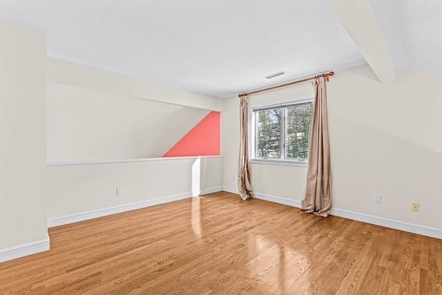 bonus room featuring vaulted ceiling with beams and light wood-type flooring