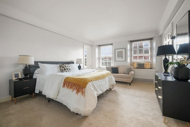 bedroom featuring crown molding and light colored carpet