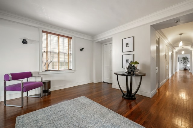 living area with dark hardwood / wood-style flooring and ornamental molding