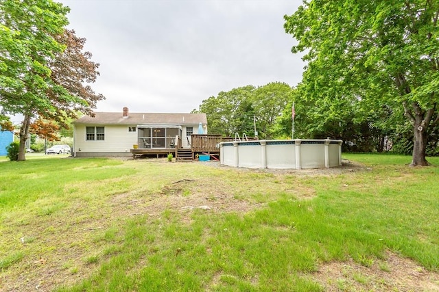22 Bayview Ave, Berkley, MA 02779 - view of grassy yard featuring a deck, an outdoor pool, and a sunroom