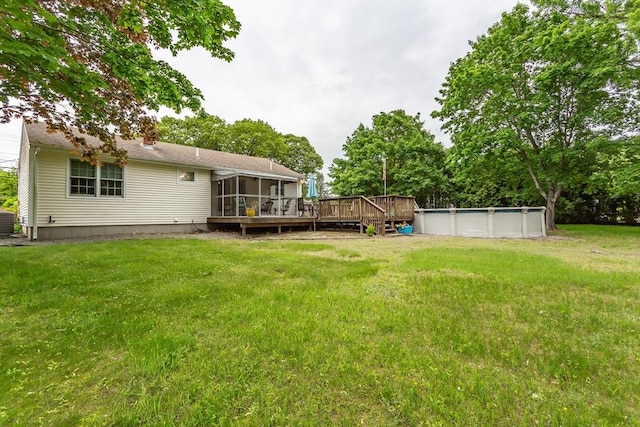 22 Bayview Ave, Berkley, MA 02779 - view of grassy yard with a sunroom, a wooden deck, an outdoor pool, and central AC unit