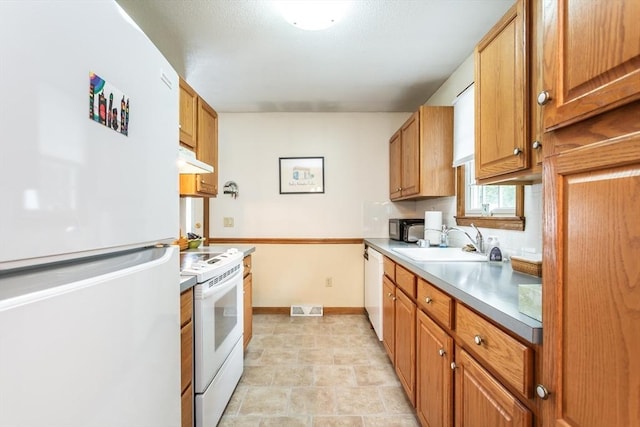 22 Bayview Ave, Berkley, MA 02779 - kitchen with white appliances, a sink, under cabinet range hood, and brown cabinetry