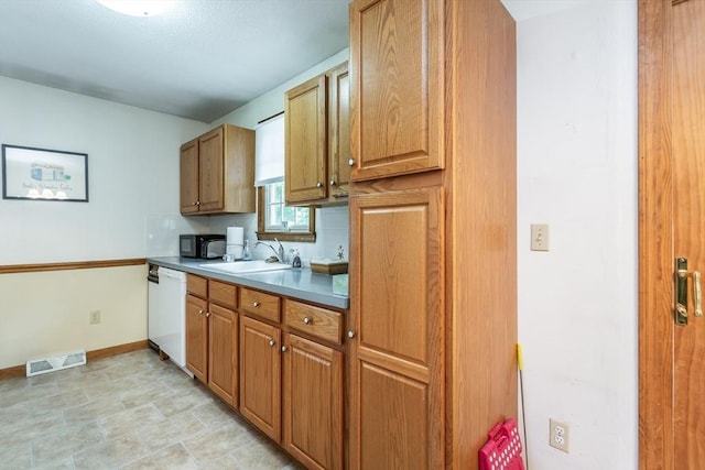 22 Bayview Ave, Berkley, MA 02779 - kitchen with white dishwasher, a sink, and brown cabinetry