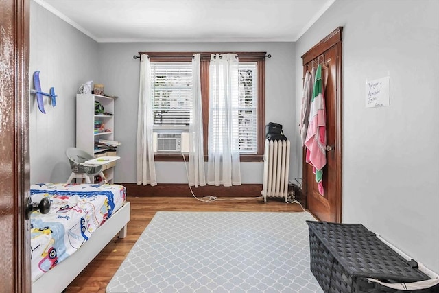 6-8 Maurice Ave, Lawrence, MA 01841 - bedroom with wood finished floors, crown molding, radiator, and cooling unit