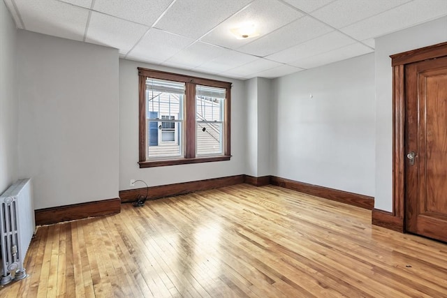 6-8 Maurice Ave, Lawrence, MA 01841 - empty room featuring radiator, light wood-style flooring, and a paneled ceiling