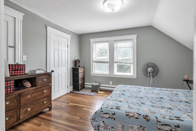 6-8 Maurice Ave, Lawrence, MA 01841 - bedroom featuring wood finished floors, vaulted ceiling, and a baseboard heating unit