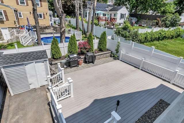 6-8 Maurice Ave, Lawrence, MA 01841 - wooden terrace with a fenced backyard, grilling area, and a storage shed