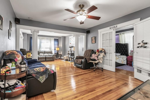 6-8 Maurice Ave, Lawrence, MA 01841 - living room featuring ornate columns, light wood finished floors, and a ceiling fan