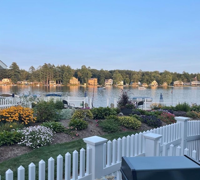 property view of water featuring fence