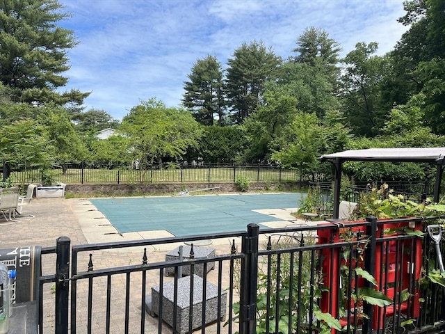 view of swimming pool with a fenced in pool, a patio, and fence