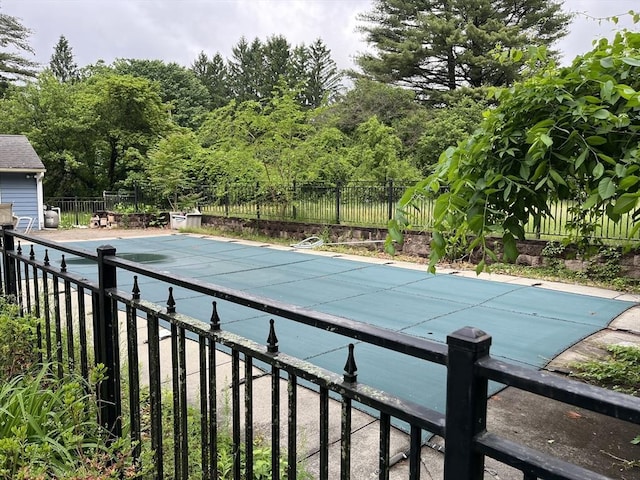 view of pool with a fenced in pool, a patio area, and fence