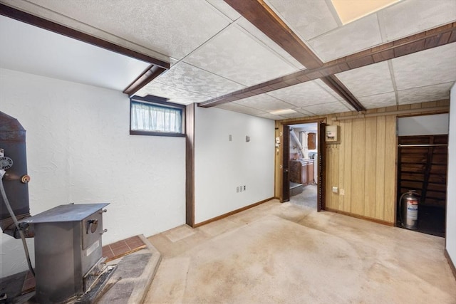 141 Hobart St, Braintree, MA 02184 - basement with a wood stove, wood walls, and baseboards