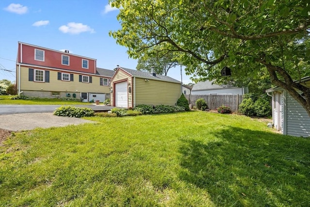 141 Hobart St, Braintree, MA 02184 - view of yard featuring an outbuilding, a garage, and driveway