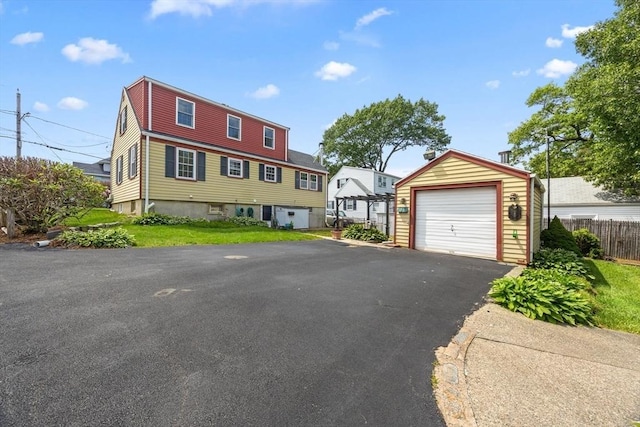 141 Hobart St, Braintree, MA 02184 - view of front of house featuring an outbuilding, asphalt driveway, and a garage