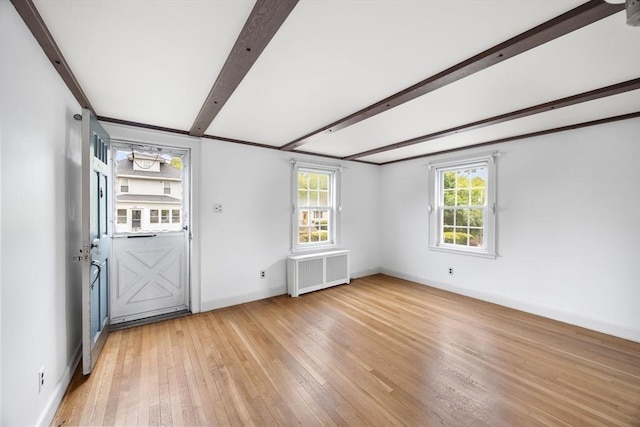 141 Hobart St, Braintree, MA 02184 - spare room featuring radiator heating unit, light wood finished floors, baseboards, and beamed ceiling