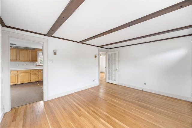 141 Hobart St, Braintree, MA 02184 - empty room featuring beam ceiling, baseboards, and light wood finished floors