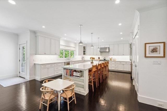 40 Carver Rd, Wellesley, MA 02481 - kitchen featuring a center island, under cabinet range hood, white cabinets, backsplash, and recessed lighting