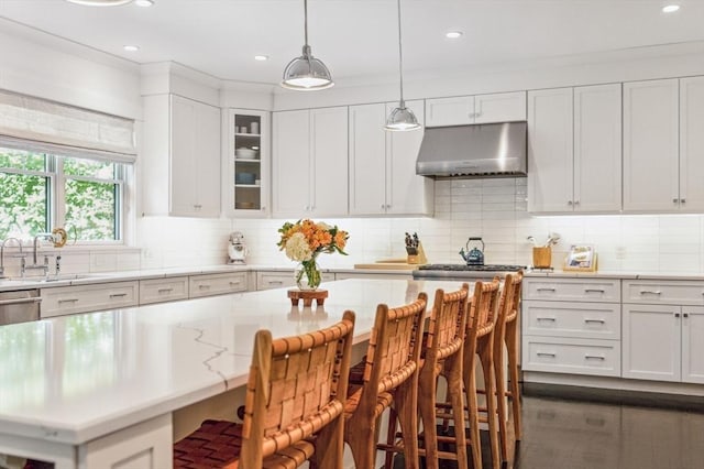 40 Carver Rd, Wellesley, MA 02481 - kitchen featuring ventilation hood, white cabinets, a kitchen bar, tasteful backsplash, and recessed lighting