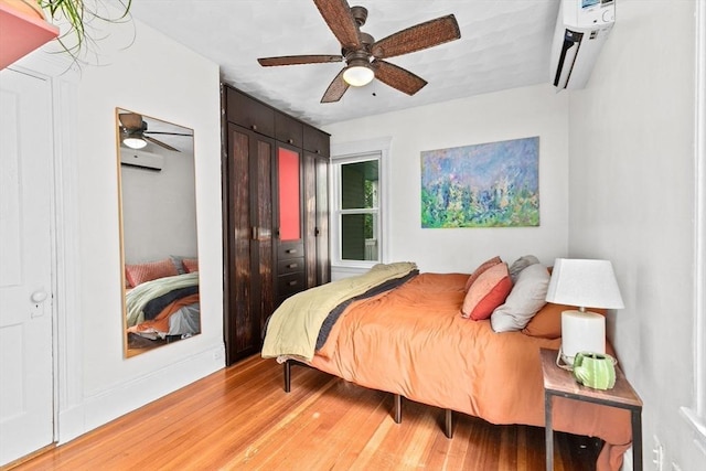 1 King St Unit 3, Boston, MA 02122 - bedroom featuring light wood finished floors, a wall unit AC, ceiling fan, and baseboards