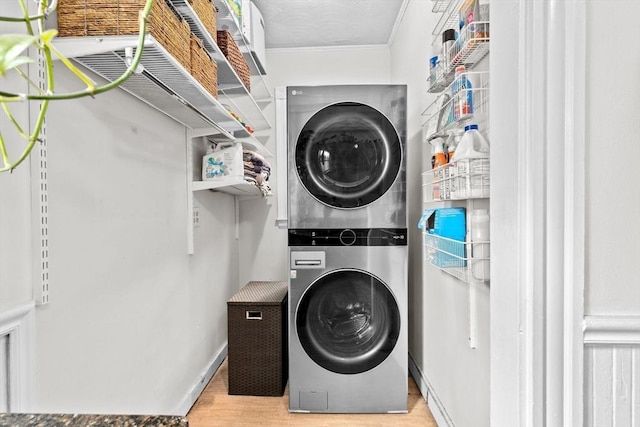 1 King St Unit 3, Boston, MA 02122 - laundry area featuring stacked washer and clothes dryer, ornamental molding, and wood finished floors