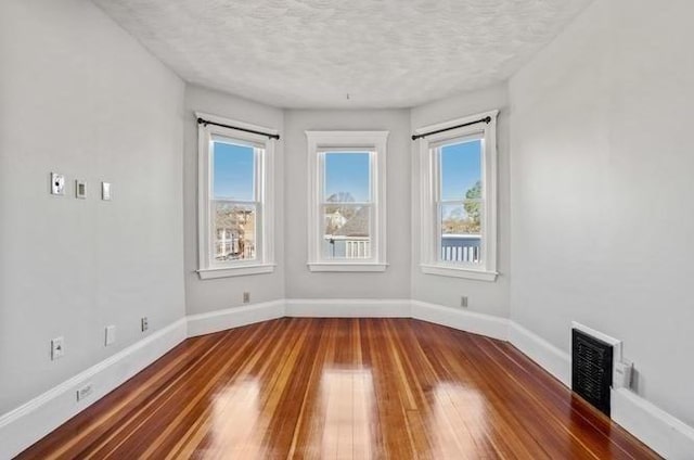 1 King St Unit 3, Boston, MA 02122 - spare room featuring hardwood / wood-style floors, a textured ceiling, and baseboards