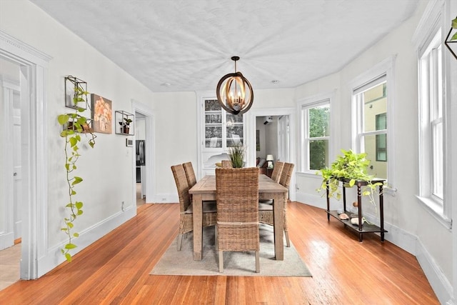 1 King St Unit 3, Boston, MA 02122 - dining space with a chandelier, light wood finished floors, and baseboards