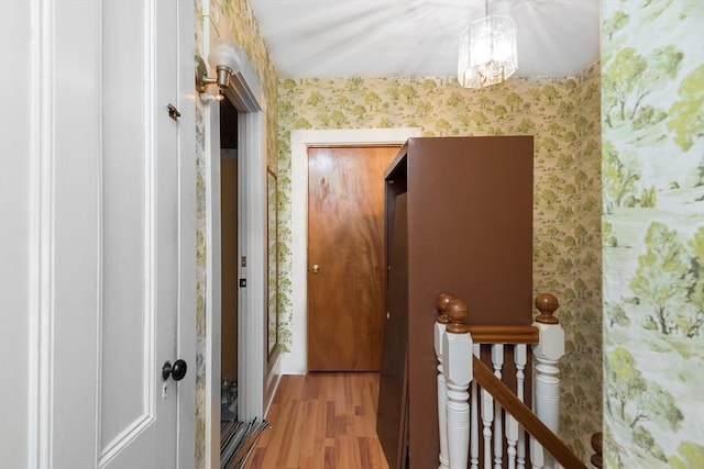 98 Safford St, Quincy, MA 02171 - hall featuring wallpapered walls, an upstairs landing, wood finished floors, and a chandelier