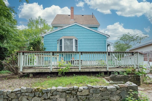 98 Safford St, Quincy, MA 02171 - back of house with a chimney, a wooden deck, and roof with shingles