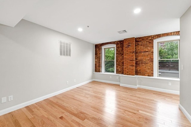 72 River St Unit 5, Haverhill, MA 01832 - unfurnished room featuring healthy amount of natural light, light wood-style flooring, baseboards, recessed lighting, and brick wall