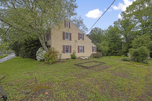 50 Humphrey St, Marblehead, MA 01945 - rear view of house featuring a lawn