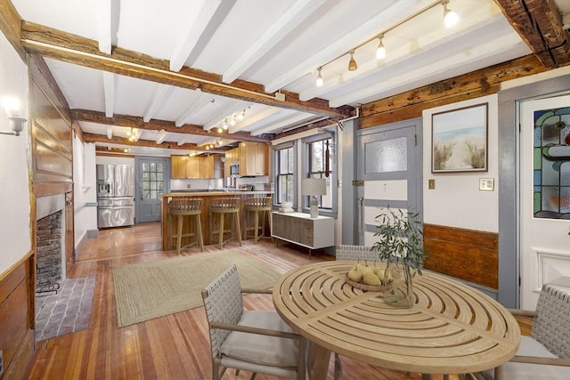 50 Humphrey St, Marblehead, MA 01945 - living room with hardwood / wood-style flooring, beamed ceiling, rail lighting, and a fireplace