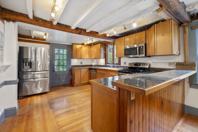 50 Humphrey St, Marblehead, MA 01945 - kitchen with stainless steel appliances, plenty of natural light, light wood-style floors, a peninsula, and beam ceiling