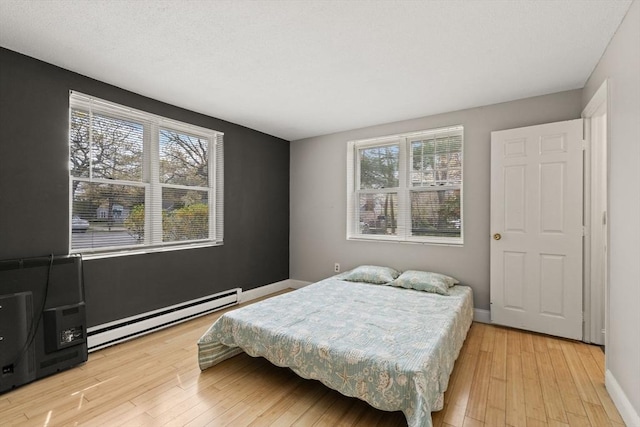 733 W Main Unit G, Barnstable, MA 02630 - bedroom featuring a baseboard heating unit, light wood finished floors, and baseboards