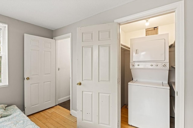 733 W Main Unit G, Barnstable, MA 02630 - laundry area with stacked washer and clothes dryer and light wood-style floors
