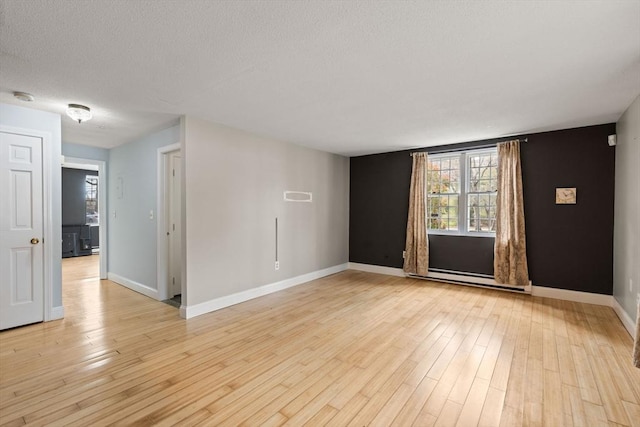 733 W Main Unit G, Barnstable, MA 02630 - unfurnished room featuring healthy amount of natural light, baseboards, light wood finished floors, and a textured ceiling