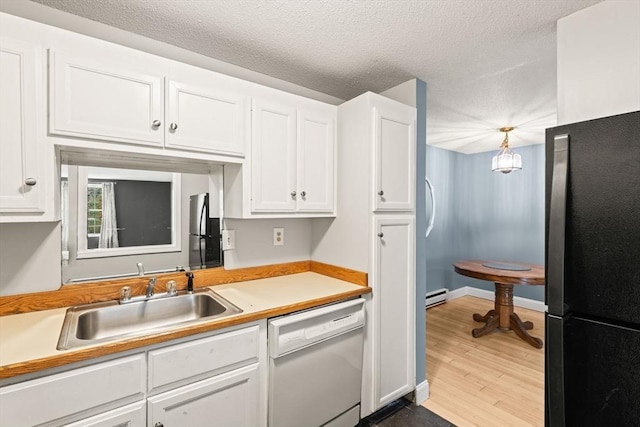 733 W Main Unit G, Barnstable, MA 02630 - kitchen featuring dishwasher, a sink, freestanding refrigerator, white cabinets, and a textured ceiling