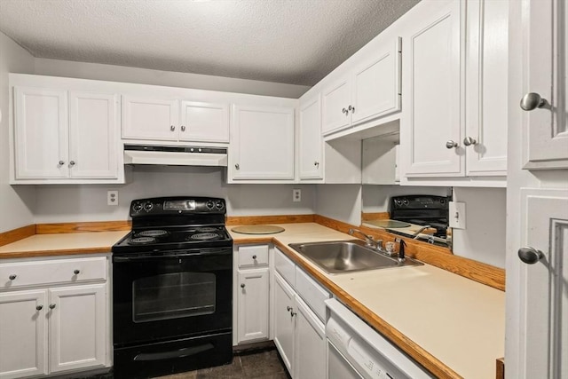 733 W Main Unit G, Barnstable, MA 02630 - kitchen featuring black electric range, under cabinet range hood, a sink, white cabinetry, and a textured ceiling