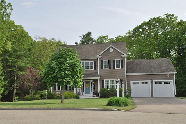12 Cranberry Ln, Wrentham, MA 02093 - view of front facade featuring a garage, concrete driveway, and a front lawn