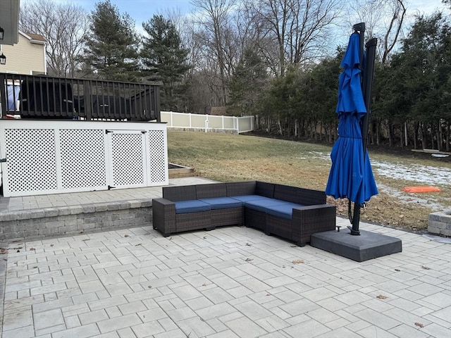 view of patio featuring fence and an outdoor living space