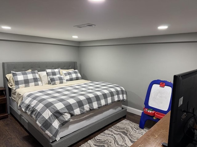 bedroom with recessed lighting, visible vents, baseboards, and wood finished floors