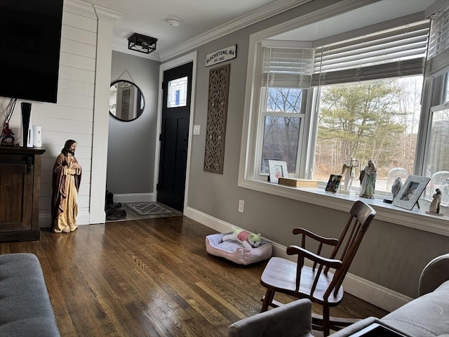 entrance foyer featuring ornamental molding, wood finished floors, and baseboards