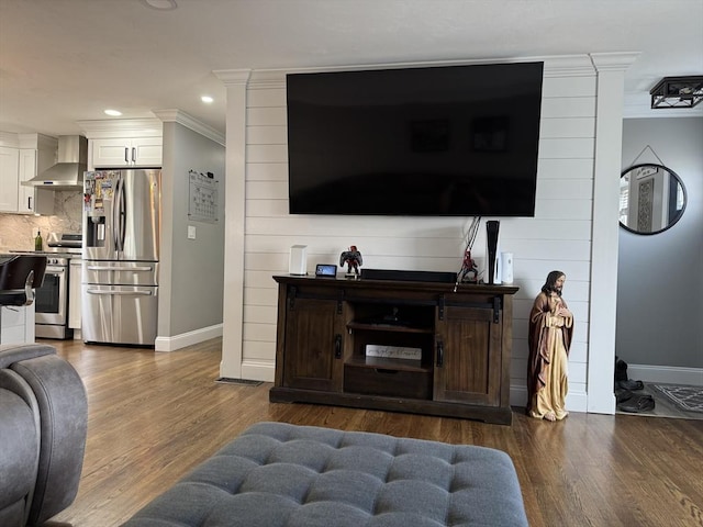 living room with baseboards, dark wood finished floors, and crown molding