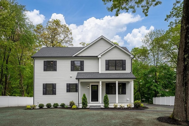 view of front facade featuring a porch and a shingled roof