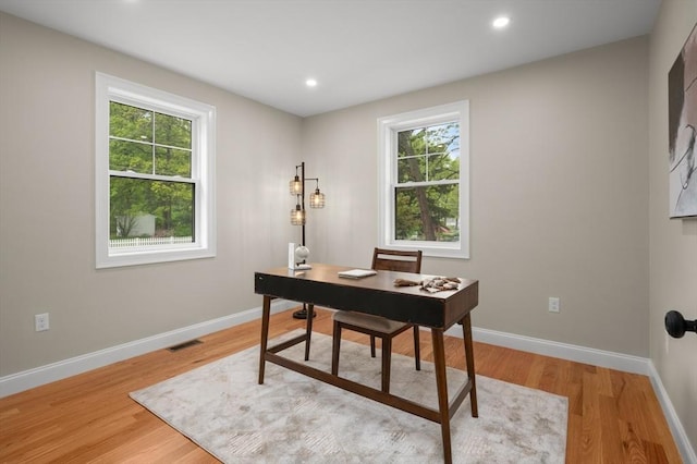 office space featuring healthy amount of natural light, light wood finished floors, baseboards, and recessed lighting