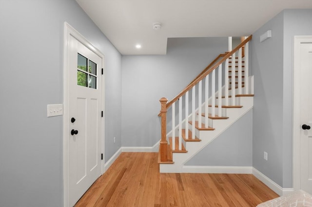 entrance foyer with wood finished floors, stairs, baseboards, and recessed lighting