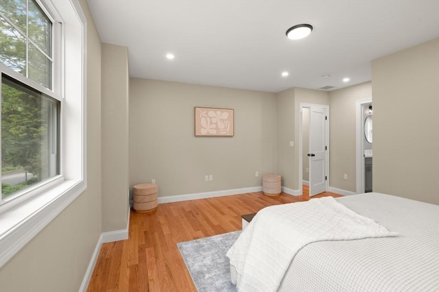 bedroom with light wood-style floors, multiple windows, baseboards, and recessed lighting