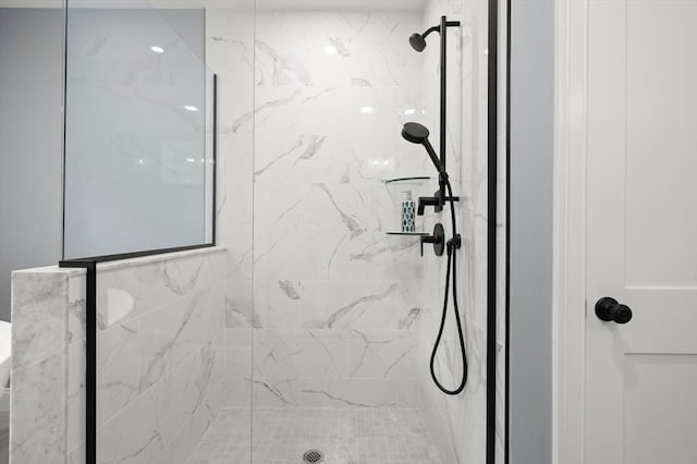 bathroom with a marble finish shower