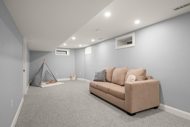 carpeted living area with recessed lighting and baseboards