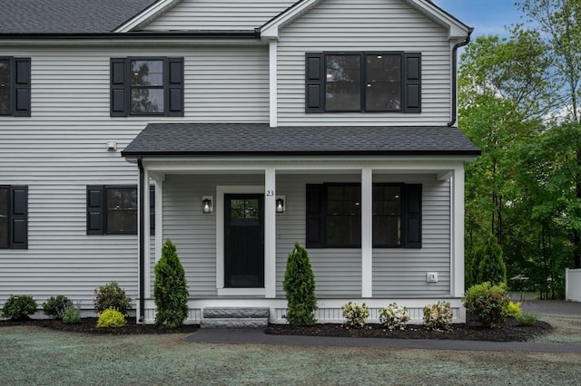 view of front of property with a porch and roof with shingles