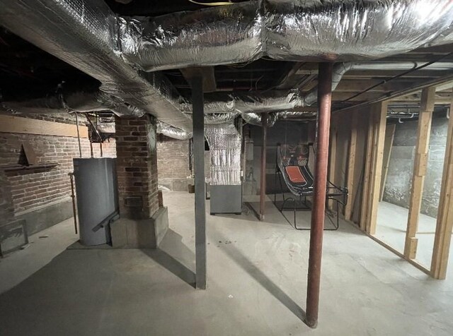 95 Prospect Street Ext, Westfield, MA 01085 - unfinished basement featuring brick wall, water heater, and heating unit